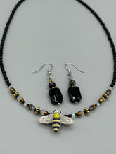 Load image into Gallery viewer, Elegantly crafted from black rectangular and circular glass beads, these dainty earrings offer a versatile style that can effortlessly elevate any ensemble.  Measurements: 1 3/8” in length