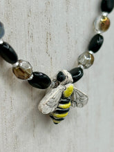 Load image into Gallery viewer, This beautiful Bee Pendant With Black and Yellow Beaded Necklace is the perfect accessory for any summer outfit. The vibrant colors will make a bold statement, while the black and gold blend adds a subtle elegance. Its perfect for any nature lover, hippie, or witchy style.  Measurements:  Necklace is 18”