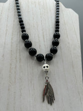 Load image into Gallery viewer, This elegant Peruvian ceramic skull beaded necklace is the perfect accessory for your unique look. With a large skull bead and a lucky hand charm, it exudes a dark, alluring vibe. Complemented with black glass and hematite stone beads, it will make a bold statement. Measurements: Necklace: 19” in length - skulls with lucky hand charm is 2 3/4” Height