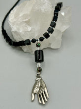 Load image into Gallery viewer, This elegant black obsidian square-shaped beaded necklace is the perfect accessory for your unique look. With a large black bead adorned with multi-color cloisonné bead and a lucky hand charm, it exudes a dark, alluring vibe. Complemented with black glass and hematite stone beads, it will make a bold statement. Measurements: Necklace: 18” in length - lucky hand charm is 3 1 /2” Height