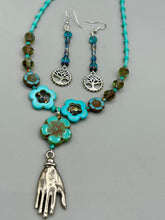 Load image into Gallery viewer, This captivating set of earrings boasts an exquisite range of intense blues and purples, accented with a warm touch of gold and green. The dangling silver plated tree of life charm adds a beautiful finishing touch.  Measurements: 2 1/2” in length