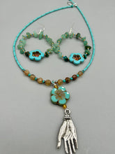 Load image into Gallery viewer, This pair of earrings features a turquoise magnesite floral bead with a vibrant orange glass bead and natural green aventurine stone chips juxtaposed against gold and blue glass beads. Measurements: 2" length