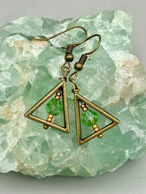 Load image into Gallery viewer, Antique antique brass plated steel ear-wire French Hook Earrings. Antique brass triangle dangle earrings feature a light green round glass beads with tiny small gold tone beads. Unique style earrings display a beautiful complimentary tones between the light green beads and the warm brass tone. Antique antique brass plated steel ear-wire French Hook Earrings. Measurements: 1" length