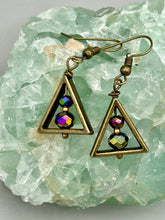 Load image into Gallery viewer, Antique brass triangle dangle earrings feature a purple tone glass bead with an iridescent shimmer finish showcasing hues of gold, purple, blue and pink. Unique style earrings display a beautiful contras between the dark and cool tone glass beads and the warm brass tone. Antique brass plated steel ear-wire French Hook Earrings. Measurements: 1" length