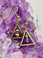 Load image into Gallery viewer, Antique brass triangle dangle earrings feature a purple tone glass bead with an iridescent shimmer finish showcasing hues of gold, purple, blue and pink. Unique style earrings display a beautiful contras between the dark and cool tone glass beads and the warm brass tone. Antique brass plated steel ear-wire French Hook Earrings. Measurements: 1" length