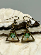 Load image into Gallery viewer, Antique antique brass plated steel ear-wire French Hook Earrings. Antique brass triangle dangle earrings feature a light green round glass beads with tiny small gold tone beads. Unique style earrings display a beautiful complimentary tones between the light green beads and the warm brass tone. Antique antique brass plated steel ear-wire French Hook Earrings. Measurements: 1" length