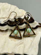Load image into Gallery viewer, Antique antique brass plated steel ear-wire French Hook Earrings. Antique brass triangle dangle earrings feature a light mint green melon Czech faceted round glass beads with a tint of light gold shimmer. Unique style earrings display a beautiful complimentary tones between the light mint green beads and the warm brass tone. Antique antique brass plated steel ear-wire French Hook Earrings. Measurements: 1" length