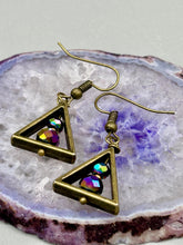 Load image into Gallery viewer, Antique brass triangle dangle earrings feature a purple tone glass bead with an iridescent shimmer finish showcasing hues of gold, purple, blue and pink. Unique style earrings display a beautiful contras between the dark and cool tone glass beads and the warm brass tone. Antique brass plated steel ear-wire French Hook Earrings. Measurements: 1" length