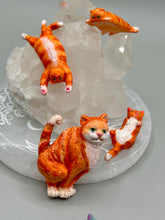 Load image into Gallery viewer, Cat lovers dream, this hand-crafted orange tabby cat magnet art is the purrfect decoration on refrigerators, lockers, cubicles or toolboxes. The set includes three mini cat figurines, featuring emerald green eyes. Measurements: H 2” x W 1/2” x D 3/8” - Cat Magnet H 2” x W 3/8” x D 3/8” - Cat Figurines