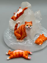 Load image into Gallery viewer, Cat lovers dream, this hand-crafted orange tabby cat magnet art is the purrfect decoration on refrigerators, lockers, cubicles or toolboxes. The set includes three mini cat figurines, featuring emerald green eyes. Measurements: H 2” x W 1/2” x D 3/8” - Cat Magnet H 2” x W 3/8” x D 3/8” - Cat Figurines