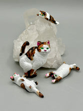 Load image into Gallery viewer, Cat lovers dream, this hand-crafted calico cat magnet art is the purrfect decoration on refrigerators, lockers, cubicles or toolboxes. The set includes one large cat magnet and three mini cat figurines, featuring emerald green eyes. Measurements: H 2” x W 1/2” x D 3/8” - Cat Magnet H 2” x W 3/8” x D 3/8” - Cat Figurines