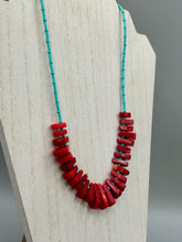 Load image into Gallery viewer, Experience the striking beauty of Southwest Style with this necklace adorned with vibrant blue turquoise and bold red coral beads. Complete the look with matching earrings, perfect for any occasion. Skillfully crafted using metal wire and secured with a hook-eye clasp for a secure and stylish finish.
Measurements: 21" in length