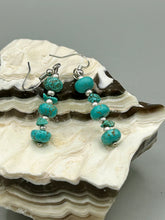 Load image into Gallery viewer, Experience the striking beauty of Southwest Style with this necklace adorned with vibrant blue turquoise and bold red coral beads. Complete the look with matching earrings, perfect for any occasion. Skillfully crafted using metal wire and secured with a hook-eye clasp for a secure and stylish finish.
Measurements: 21" in length