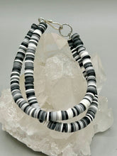 Load image into Gallery viewer, Two strand clay heishi beaded bracelet mixed with black, gray, and white. Crafted with metal wire and fastened with hook-eye clasp.
Measurements: 8 1/4" in length
