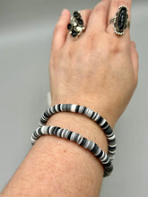 Load image into Gallery viewer, Two strand clay heishi beaded bracelet mixed with black, gray, and white. Crafted with metal wire and fastened with hook-eye clasp.
Measurements: 8 1/4" in length