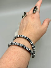 Load image into Gallery viewer, Two strand clay heishi beaded bracelet mixed with black, gray, and white. Crafted with metal wire and fastened with hook-eye clasp.
Measurements: 8 1/4" in length