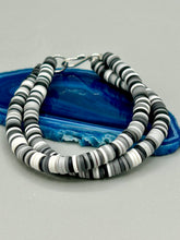 Load image into Gallery viewer, Two strand clay heishi beaded bracelet mixed with black, gray, and white. Crafted with metal wire and fastened with hook-eye clasp.
Measurements: 8 1/4" in length
