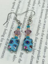 Load image into Gallery viewer, This bold and vibrant piece of jewelry features blue, purple, and gold glass beads of different sizes and shapes that are artfully combined to create a unique texture. An essential addition to any jewelry collection. Measurements: 1 ” in length