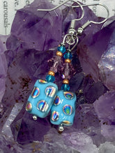 Load image into Gallery viewer, This bold and vibrant piece of jewelry features blue, purple, and gold glass beads of different sizes and shapes that are artfully combined to create a unique texture. An essential addition to any jewelry collection. Measurements: 1 ” in length