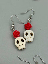 Load image into Gallery viewer, These stylish skull earrings are perfect for adding a unique flair to any outfit. Whether you're looking for a Dia De Los Muertos accessory or simply looking to draw inspiration, these goth pieces perfectly capture the vampire goth, witchy, dark, Chingona Cabrona, Latina Chicana styles. Crafted with Howlite stone skull beads and pink coral quartzize floral beaded earrings, this jewelry set is a unique stunning statement piece.  Measurements: 1 1/4 ” in length