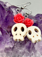 Load image into Gallery viewer, These stylish skull earrings are perfect for adding a unique flair to any outfit. Whether you're looking for a Dia De Los Muertos accessory or simply looking to draw inspiration, these goth pieces perfectly capture the vampire goth, witchy, dark, Chingona Cabrona, Latina Chicana styles. Crafted with Howlite stone skull beads and pink coral quartzize floral beaded earrings, this jewelry set is a unique stunning statement piece.  Measurements: 1 1/4 ” in length