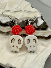Load image into Gallery viewer, These stylish skull earrings are perfect for adding a unique flair to any outfit. Whether you're looking for a Dia De Los Muertos accessory or simply looking to draw inspiration, these goth pieces perfectly capture the vampire goth, witchy, dark, Chingona Cabrona, Latina Chicana styles. Crafted with Howlite stone skull beads and pink coral quartzize floral beaded earrings, this jewelry set is a unique stunning statement piece.  Measurements: 1 1/4 ” in length