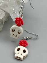 Load image into Gallery viewer, These stylish skull earrings are perfect for adding a unique flair to any outfit. Whether you're looking for a Dia De Los Muertos accessory or simply looking to draw inspiration, these goth pieces perfectly capture the vampire goth, witchy, dark, Chingona Cabrona, Latina Chicana styles. Crafted with Howlite stone skull beads and pink coral quartzize floral beaded earrings, this jewelry set is a unique stunning statement piece.  Measurements: 1 1/4 ” in length