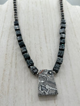 Load image into Gallery viewer, This rustic necklace features an eye-catching large trapezoid-shaped Picasso jasper, hematite, square-shaped snowflake obsidian combo set in a unique and chic design. Handcrafted from genuine stones, this necklace is perfect for any bohemian look. Measurements: Necklace is 21"