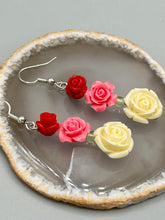 Load image into Gallery viewer, Crafted from quartzite, these highly detailed rose beads come in three striking shades of red, soft pink, and white beaded earrings. This is the ideal accessory for those interested in Dia De Los Muertos as well as those with an appreciation for gardens. Whether dressing up or down, these earrings will lend a distinctive touch to your fashion. Measurements: 1 1/2” in length