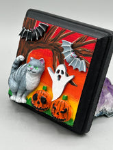 Load image into Gallery viewer, This handcrafted Halloween theme polymer clay wall art boasts a square-shaped wood frame with hand sculpted gray tabby cat, gray and black bats, jack-o-lantern and ghost motifs. Its warm sky hues, including yellow, to orange to dark red are further complemented by the black frame adding an extra layer of sophistication to the spooky warm-toned artwork.  Measurements: H 4" x W 4” x D 1 1/2"