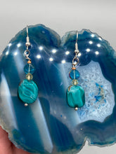 Load image into Gallery viewer, The Whimsical Teal Blue-Purple Glass Beaded Earrings feature a delightful mix of blues, purples, and hints of gold, along with varied sizes and shapes for an eye-catching textural look. The quartzite beads have a captivating swirl pattern, combining dark red and dark blue hues. Measurements: 1 1/2 ” in length