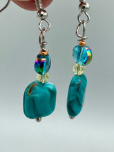 Load image into Gallery viewer, The Whimsical Teal Blue-Purple Glass Beaded Earrings feature a delightful mix of blues, purples, and hints of gold, along with varied sizes and shapes for an eye-catching textural look. The quartzite beads have a captivating swirl pattern, combining dark red and dark blue hues. Measurements: 1 1/2 ” in length