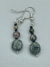 Load image into Gallery viewer, These earrings are crafted with turmaline quartz, snowflake obsidian and black glass beads, creating a neutral cool look that is both unique and adaptable to any style. Measurements: 1 1/2” in length