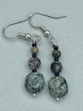 Load image into Gallery viewer, These earrings are crafted with turmaline quartz, snowflake obsidian and black glass beads, creating a neutral cool look that is both unique and adaptable to any style. Measurements: 1 1/2” in length