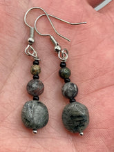 Load image into Gallery viewer, These earrings are crafted with turmaline quartz, snowflake obsidian and black glass beads, creating a neutral cool look that is both unique and adaptable to any style. Measurements: 1 1/2” in length