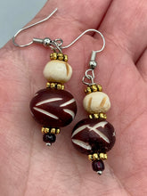 Load image into Gallery viewer, Crafted with large and small round bone beads, these gold-tone floral metal bead earrings come in a range of neutral colors. Their versatile design allows them to transition easily from casual to formal, offering a unique edge to any ensemble. Measurements: 1 1/2 ” in length