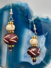 Load image into Gallery viewer, Crafted with large and small round bone beads, these gold-tone floral metal bead earrings come in a range of neutral colors. Their versatile design allows them to transition easily from casual to formal, offering a unique edge to any ensemble. Measurements: 1 1/2 ” in length