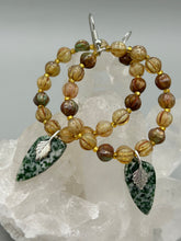 Load image into Gallery viewer, Green-White Qinghai Green Jasper Stone Beaded Hoop Earrings provide a nature-inspired look that is perfect for any boho-chic style. These earrings feature natural green jasper stone triangle pendant with champagne mix melon Czech faceted round glass beads. Glass beads have a tint of light champagne, amber, dark green and gold shimmer for subtle accent. Show off your bohemian look with these eye-catching hoops. Antique Copper Plated Surgical Steel Hammered Long Ear-wire French Hook Earrings.