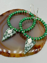 Load image into Gallery viewer, Green-White Qinghai Green Jasper Stone Beaded Hoop Earrings provide a nature-inspired look that is perfect for any boho-chic style. These earrings feature natural green jasper stone triangle pendant with small beads of silver and dark apple green magnesite stone for subtle accent. Show off your bohemian look with these eye-catching hoops. Measurements: 3" length
