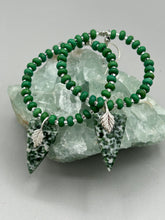 Load image into Gallery viewer, Green-White Qinghai Green Jasper Stone Beaded Hoop Earrings provide a nature-inspired look that is perfect for any boho-chic style. These earrings feature natural green jasper stone triangle pendant with small beads of silver and dark apple green magnesite stone for subtle accent. Show off your bohemian look with these eye-catching hoops. Measurements: 3" length