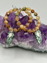 Load image into Gallery viewer, Green-White Qinghai Green Jasper Stone Beaded Hoop Earrings provide a nature-inspired look that is perfect for any boho-chic style. These earrings feature natural green jasper stone triangle pendant with champagne mix melon Czech faceted round glass beads. Glass beads have a tint of light champagne, amber, dark green and gold shimmer for subtle accent. Show off your bohemian look with these eye-catching hoops. Antique Copper Plated Surgical Steel Hammered Long Ear-wire French Hook Earrings.