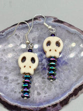 Load image into Gallery viewer, Spooky skull beads come with spine earrings. These stylish skull earrings are perfect for adding a unique flair to any outfit. Whether you're looking for a Dia De Los Muertos accessory or simply looking to draw inspiration, these goth pieces perfectly capture the vampire goth, witchy, dark, Chingona Cabrona, Latina Chicana styles. Measurements: 1 1/4” in length