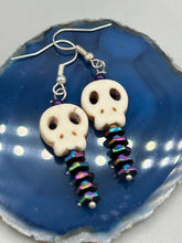 Load image into Gallery viewer, Spooky skull beads come with spine earrings. These stylish skull earrings are perfect for adding a unique flair to any outfit. Whether you're looking for a Dia De Los Muertos accessory or simply looking to draw inspiration, these goth pieces perfectly capture the vampire goth, witchy, dark, Chingona Cabrona, Latina Chicana styles. Measurements: 1 1/4” in length
