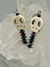 Load image into Gallery viewer, Spooky skull beads come with spine earrings. These stylish skull earrings are perfect for adding a unique flair to any outfit. Whether you're looking for a Dia De Los Muertos accessory or simply looking to draw inspiration, these goth pieces perfectly capture the vampire goth, witchy, dark, Chingona Cabrona, Latina Chicana styles. Measurements: 1 1/4” in length