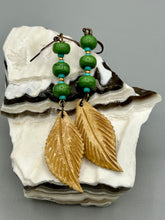 Load image into Gallery viewer, Single-stranded earring features bone carved leaf charm earrings with bright green magnesite stone and blue turquoise and gold glass beads. Antique Copper Plated Surgical Steel Hammered Long Ear-wire French Hook Earrings. Measurements: 3” in length