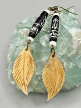 Load image into Gallery viewer, Single-stranded earring features bone carved leaf charm earrings with black and white bone carved floral design beads. Antique brass-plated steel ear-wire French Hook Earrings.   Measurements: 3” in length