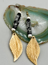 Load image into Gallery viewer, Single-stranded earring features bone carved leaf charm earrings with black and white bone carved floral design beads. Antique brass-plated steel ear-wire French Hook Earrings.   Measurements: 3” in length