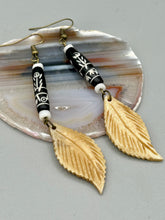 Load image into Gallery viewer, Single-stranded earring features bone carved leaf charm earrings with black and white bone carved floral design beads. Antique brass-plated steel ear-wire French Hook Earrings.   Measurements: 3” in length
