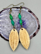 Load image into Gallery viewer, Single-stranded earring features bone carved leaf charm earrings with bright green magnesite stone beads. Antique antique brass plated steel ear-wire French Hook Earrings.  Measurements: 3” in length