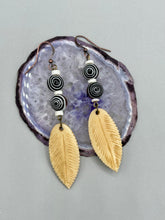 Load image into Gallery viewer, Single-stranded earring features bone carved leaf charm earrings with black and white swirly eye-dot glass beads. Antique Copper Plated Surgical Steel Hammered Long Ear-wire French Hook Earrings. Measurements: 3” in length